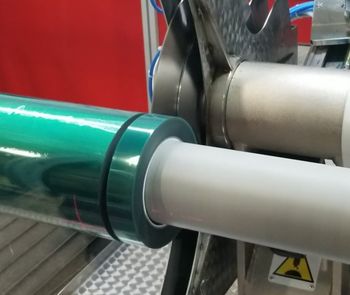 Green polyester masking tape being custom slit to width