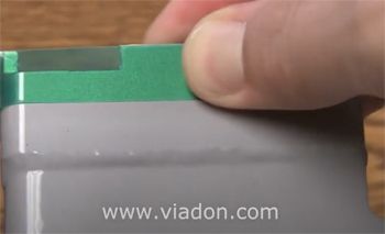 Green Poly Tape Being Pressed Down for Powder Coating Masking